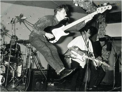 The posters for the gig were printed by Jed Moore in pink, yellow, blue and green. Ed and Vince spent many an hour paste brush and bucket in hand plastering the town, unwittingly covering Flash Harry posters.