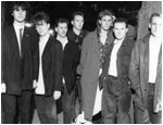 Publicity photo of BASH OUT THE ODD taken outside Birmingham International Airport in March 1990. The line up on this is (left to right) - Mark Brindley, Mark Mortimer, Martin Cooper, Pete Woodward, Stuart Pickett, Bryan Hurdley, Mark Allison.