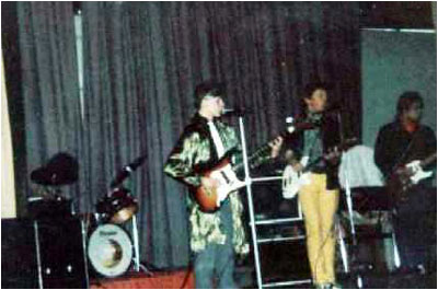 (Fetch) The Comfy Jigsaw in March 1981 playing at the QEMS School Assembly (left to right) - Donald Skinner (drums), Mark Mortimer (bass), Matthew Lees (vocals & guitar), Andrew Baines (guitar).